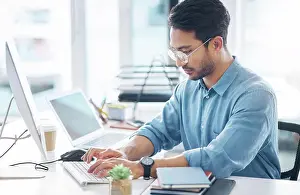 Focused Prints: Serious, business man and typing on computer in office for startup management