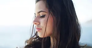 Vision Prints: Serious, woman and thinking for travel at ocean for fresh air