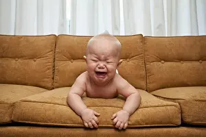 Nappy Prints: Seven month old baby on couch crying