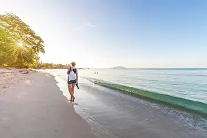 Nude Prints: Seychelles, Mahe, Beau Vallon Beach, woman walking at the beach at sunset