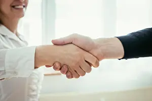 Greeting Prints: Shaking hands, concept for teamwork: Close up of man and woman shaking hands in the office