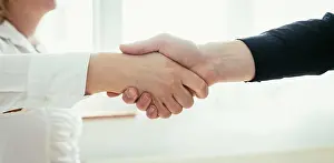 Greeting Prints: Shaking hands, concept for teamwork: Close up of man and woman shaking hands in the office