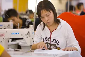 Manufacturing Prints: SHENZHEN, GUANGDONG PROVINCE, CHINA - Workers in a garment factory in city of Shenzhen