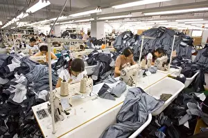 Manufacturing Prints: SHENZHEN, GUANGDONG PROVINCE, CHINA - Workers sewing Mango jeans