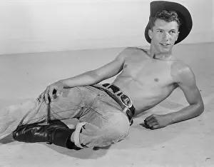 Leather Prints: Shirtless Cowboy in Jeans and Boots Relaxes c.1961