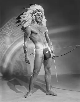 Bodybuilder Prints: Shirtless Flirtatious Male in Indigenous Costume c.1961