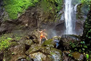 Lookingaway Prints: Shirtless man in shorts standing on rocks near waterfall, Kintamani, Bali, Indonesia