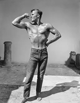 Bodybuilder Prints: Shirtless Young Bodybuilder in Jeans Flexes Bicep Outdoors c.1959