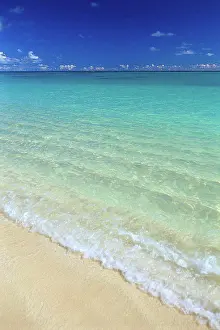 Breaking Prints: Shoreline water breaking onto shore, turquoise ocean clouds along horizon C1725