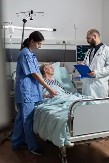 Electronics Prints: Sick senior woman getting medication through an intravenous line