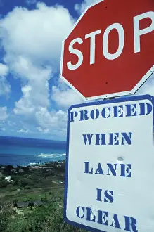 Communications Prints: A sign that reads Stop - proceed when lane is clear