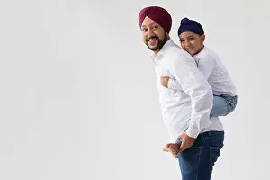Quality Time Prints: A SIKH FATHER CARRYING HIS SON ON HIS BACK SIMILING AND POSING