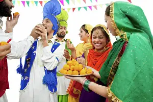 Expressions Prints: Sikh people eating laddoos