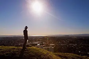 Bottle Prints: Silhouette Of A Man In A Hat Standing On Mt. Eden With A View Of Auckland; New Zealand