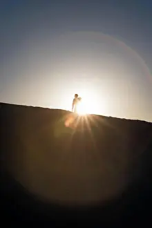 Hike Prints: Silhouette of a man standing on a Gypsum dune of White Sands National Monument in New Mexico