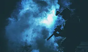 Fiery Prints: Silhouette of a soldier standing amongst smoke, armed with an assault rifle