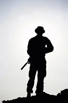 Afghanistan Prints: Silhouette of a U.S. Marine Holding a Rifle with a Suppressor