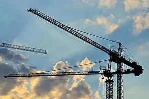 Construction Work Prints: Silhouettes of construction cranes on the sky
