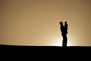 Father Prints: Silhouettes of family enjoying the early morning sun.
