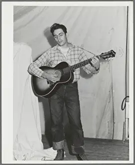 Singing cowboy songs at entertainment at the FSA (Farm Security Administration) mobile camp for migratory farm workers