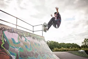 Skateboard Prints: Skateboarder skateboarding in skatepark on ramp