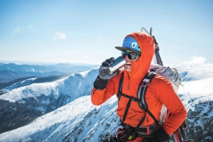 26 29 Years Old Prints: Ski mountaineer taking a break and drinking a hot beverage