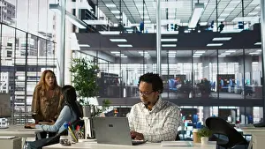 Skilled Prints: Skilled businessman at his office desk working on report writing