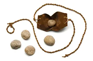 Leather Prints: Sling and five smooth stones used by David to kill Goliath on a white background