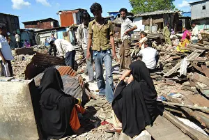 Debris Prints: Slum dwellers sit with their belongings after demolition of slums on Sahar airport Chatrapati Shivaji International
