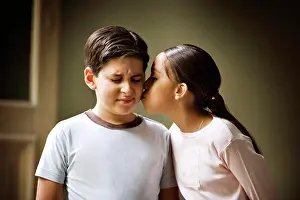 Relationships Prints: A small girl is kissing a small boy
