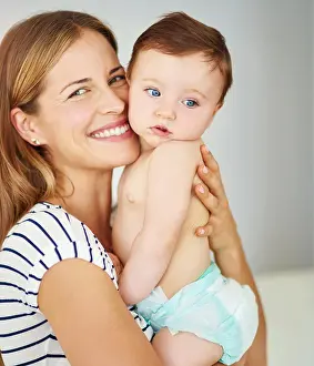 Diaper Prints: Smile, portrait and mother holding baby in diaper at home for safety
