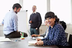 Business Women Prints: Smiling businesswoman with colleagues in background