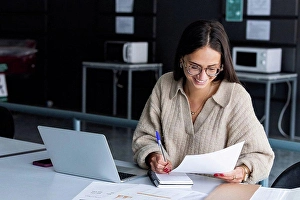 20 To 25 Years Prints: Smiling businesswoman working at office