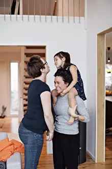 Beginnings Prints: Smiling family enjoying while standing in living room at home