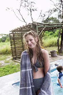 Botswana Prints: Smiling Thirteen year old girl by a swimming pool in a safari resort
