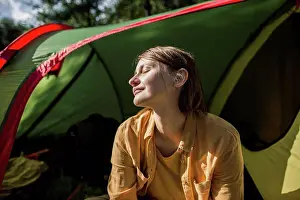 Tent Prints: Smiling woman with eyes closed sitting at tent entrance