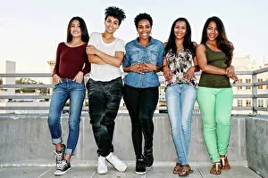 Gleeful Prints: Smiling women standing on urban rooftop