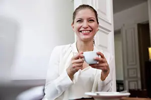 Cafeteria Prints: Smiling young woman with cup of coffee
