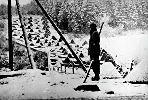 1944 Prints: Snow Scene Along The Siegfried Line - An American sentry stands guard along the Siegfried Line in Germany after