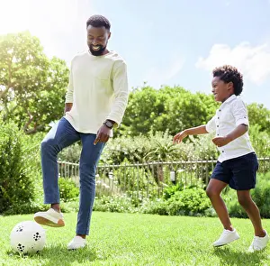 Soccer Prints: Soccer, dad and kid on a summer garden with exercise