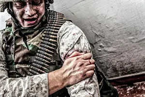 Injured Prints: Soldier clamping his gunshot wound with healthy hand to try and stop bleeding