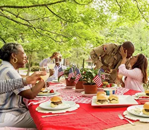 Baby Boomer Prints: Soldier man kissing wife at picnic