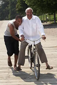 Amuse Prints: Son Pushing Father on Bicycle