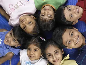 Students Prints: South Asian Indian boys and girls lay down on floor in nursery school MR