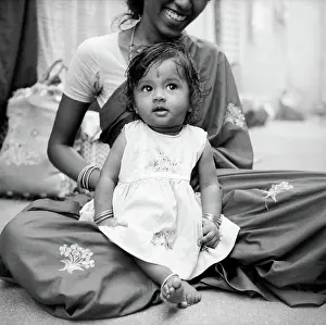 Mothers Day Prints: South Asian Indian Girl Child sitting on Mothers lap ; India