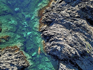 Aerial Prints: Spain, Catalonia, Costa Brava, Aerial view of man in kayak near rocky coast