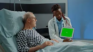 Oxygen Prints: Specialist woman showing green screen on tablet to patient