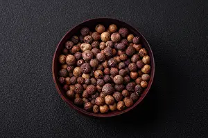 2023 Prints: Spice allspice brown color not ground in a wooden saucer