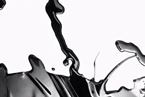 Spilling Prints: Spilled black paint making an abstract shape on white background