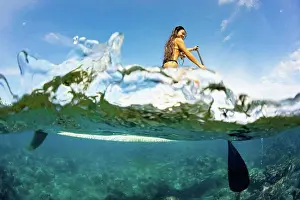 Paddle Prints: Split image of above and below water and a woman on a stand up paddle board; Hawaii